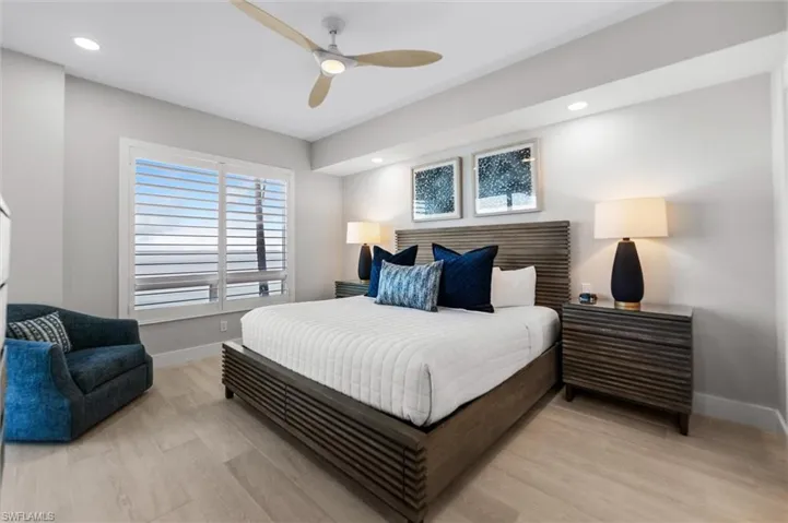 Bedroom featuring light wood-style flooring, a ceiling fan, and recessed lighting