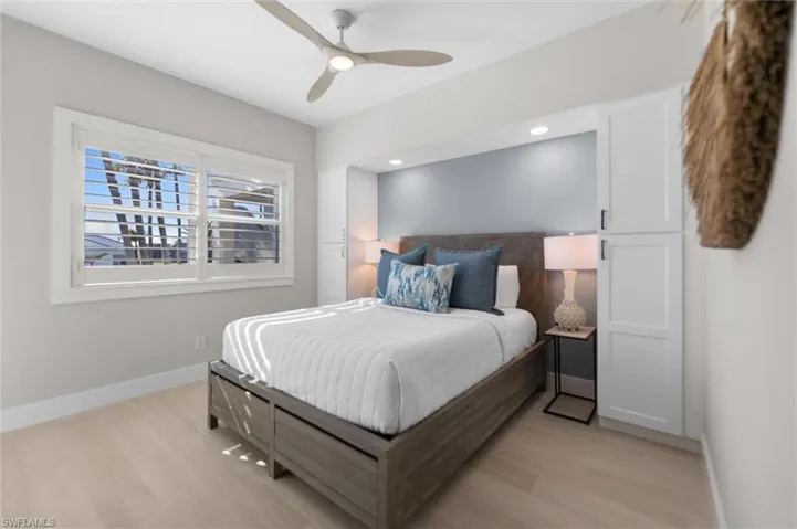 Bedroom featuring light wood finished floors, a ceiling fan, and recessed lighting