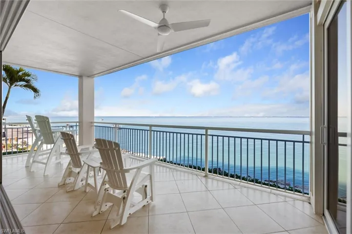 Balcony with a water view and a ceiling fan