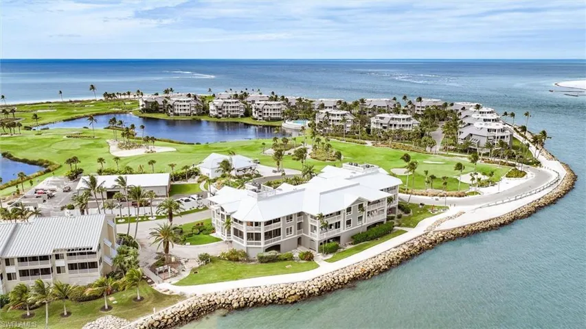 Aerial perspective of suburban area with a nearby body of water and a golf club