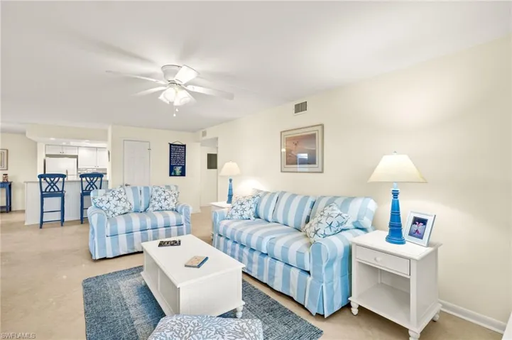 Living room featuring a ceiling fan and baseboards