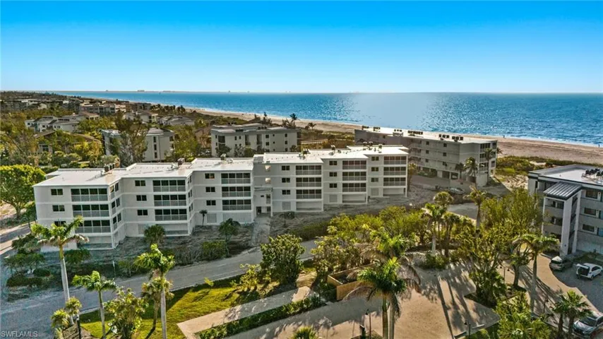 Drone / aerial view of apartment complex / building and expansive beach