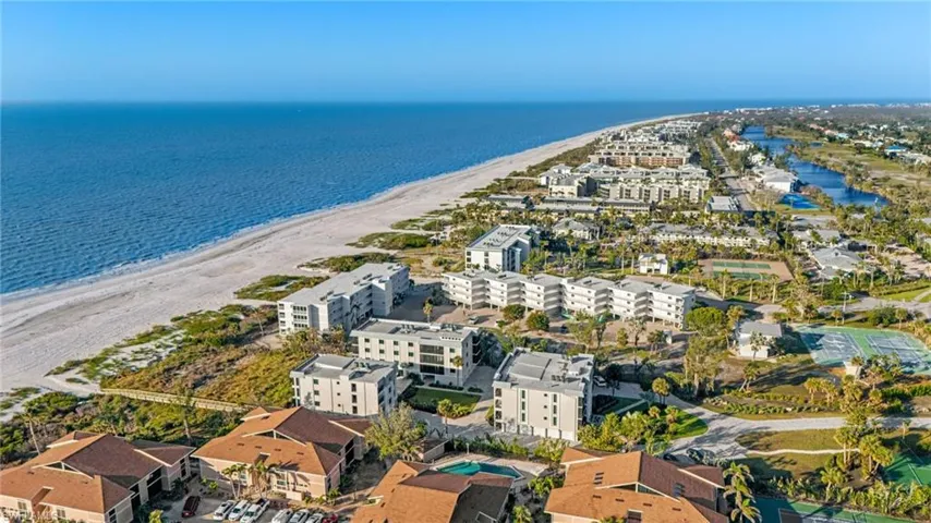 Bird's eye view of apartment complex and extended coastline