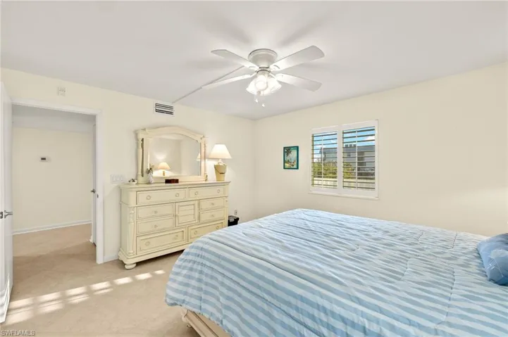 Bedroom featuring ceiling fan and light carpet