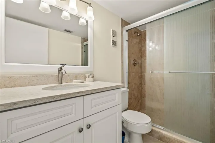 Bathroom featuring vanity and a stall shower