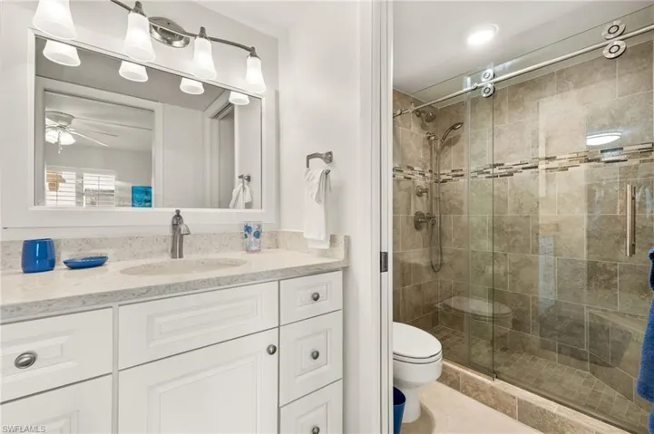 Full bathroom featuring vanity and a shower stall