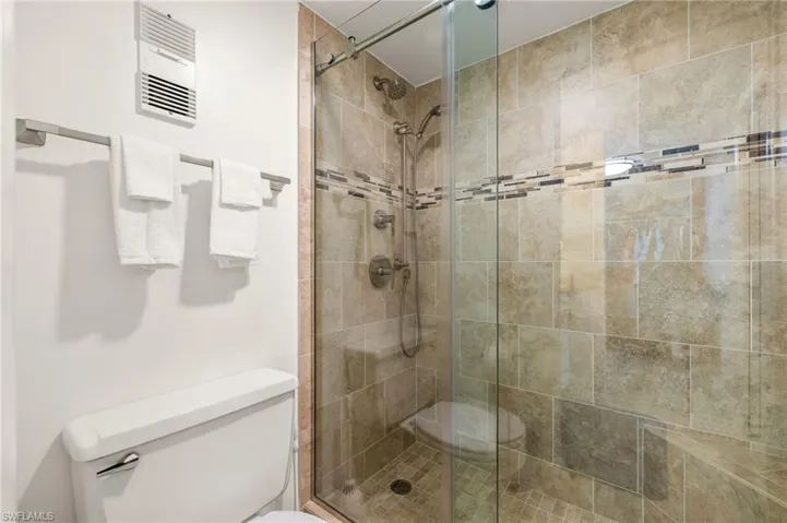 Bathroom featuring toilet and a shower stall