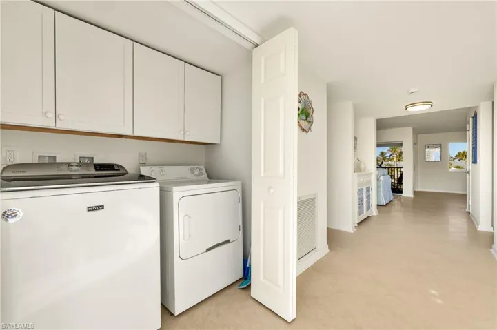 Laundry area with washing machine and clothes dryer and cabinet space
