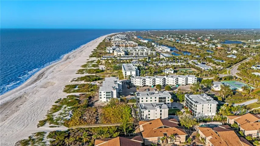 Bird's eye view of expansive coastline and apartment complex