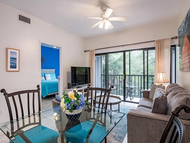 Living room featuring ceiling fan and light tile patterned floors