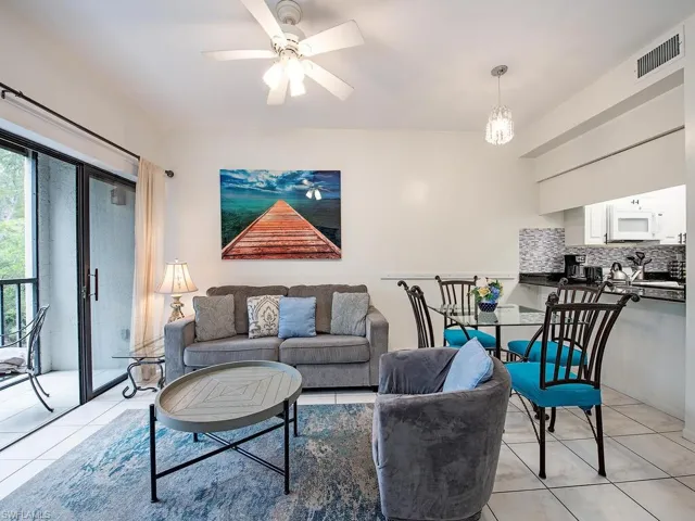 Tiled living room featuring ceiling fan