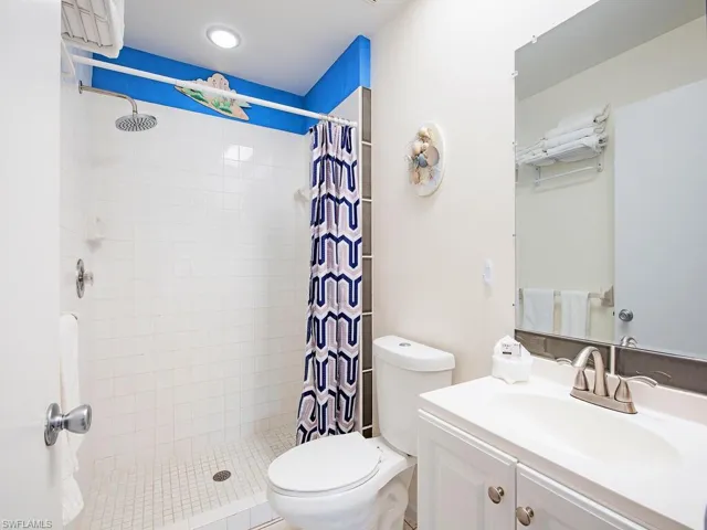 Bathroom with vanity, toilet, and walk in shower
