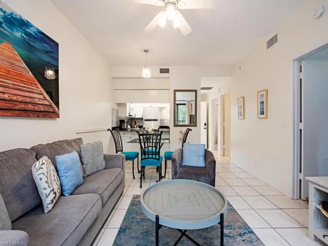 Tiled living room featuring ceiling fan