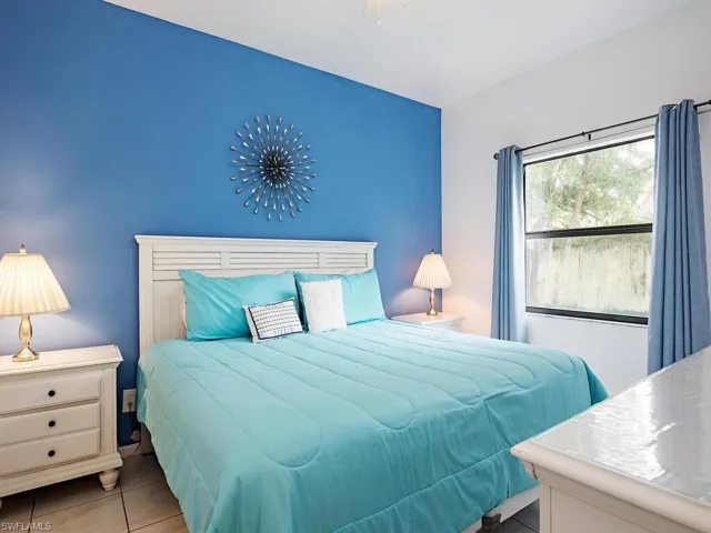 Bedroom with light tile patterned flooring