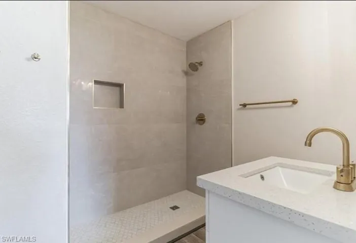 Bathroom with vanity and a tile shower