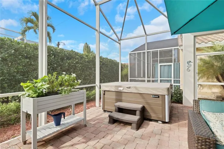 Sunroom / solarium featuring a patio area and a jacuzzi