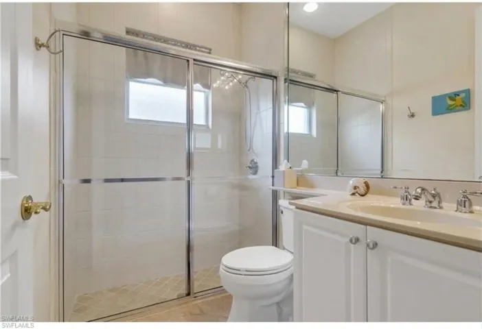 Full bath featuring vanity and a shower stall