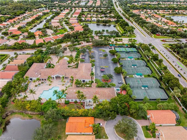 Aerial view of property's location with a large body of water and nearby suburban area