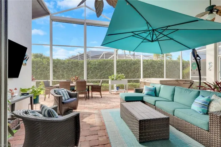 View of patio featuring an outdoor hangout area, a sunroom, glass enclosure, and outdoor dining space