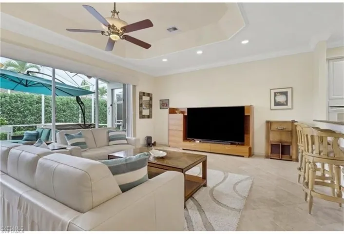 Living area featuring a sunroom, crown molding, a ceiling fan, and recessed lighting
