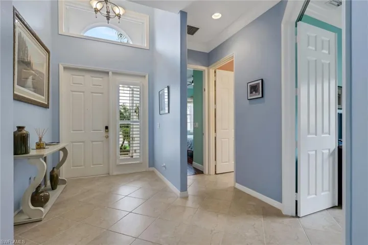 Foyer with plenty of natural light, recessed lighting, a chandelier, and light tile patterned floors
