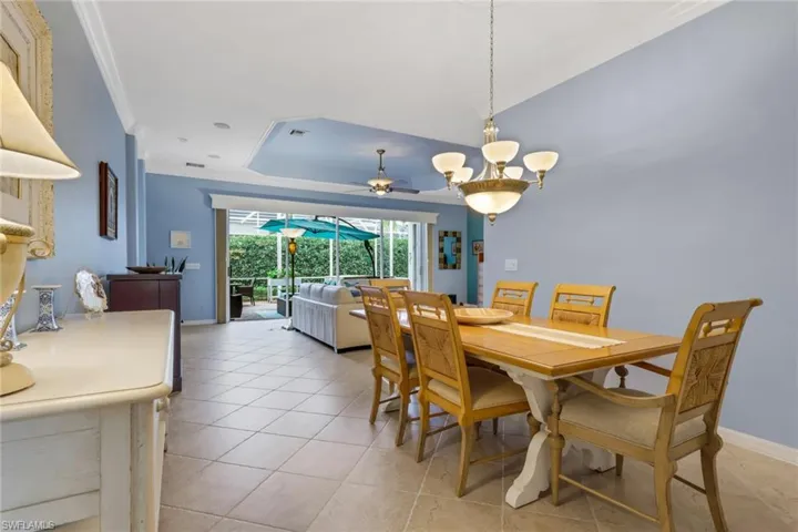 Dining room featuring ornamental molding, ceiling fan, and light tile patterned floors