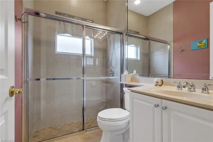 Bathroom featuring vanity and a stall shower