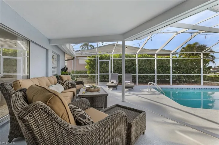 Screened lanai featuring a covered patio, integrated swimming pool, and concrete decking