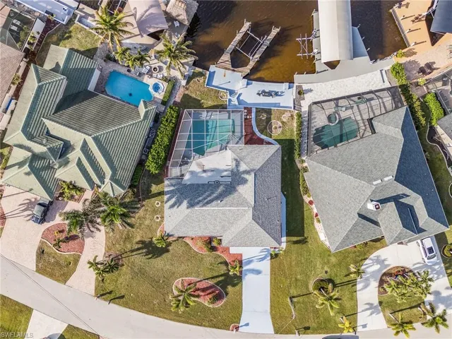Aerial view showcasing three distinct properties, each featuring a private swimming pool
