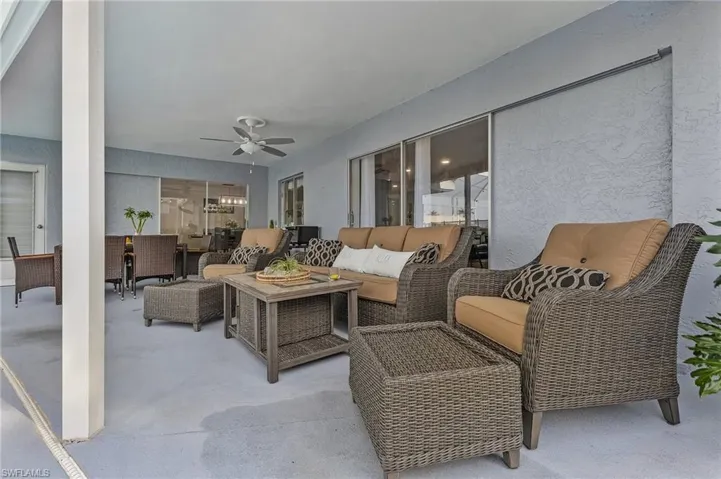 Expansive covered patio featuring a ceiling fan and sliding glass doors