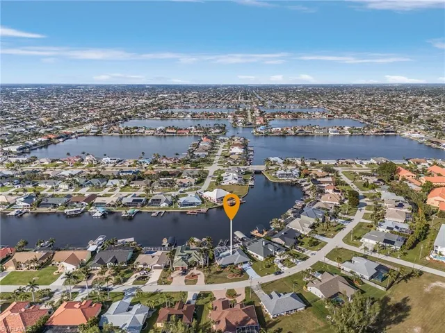 Expansive aerial view showcasing multiple waterfront properties with direct canal access