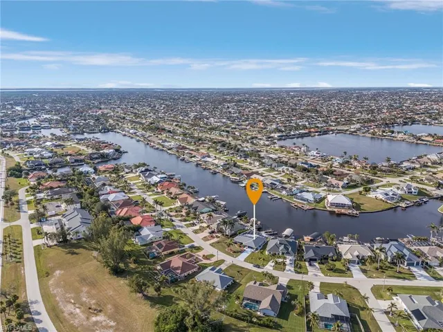 Aerial perspective showcasing a canal-front property within a residential community