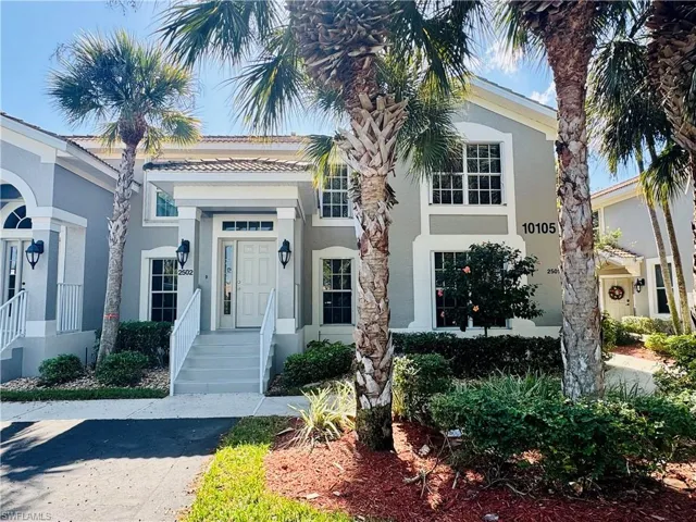 Townhome / multi-family property featuring stucco siding and a tile roof