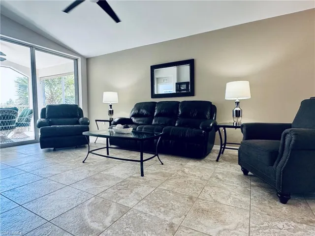 Living area with vaulted ceiling and a ceiling fan