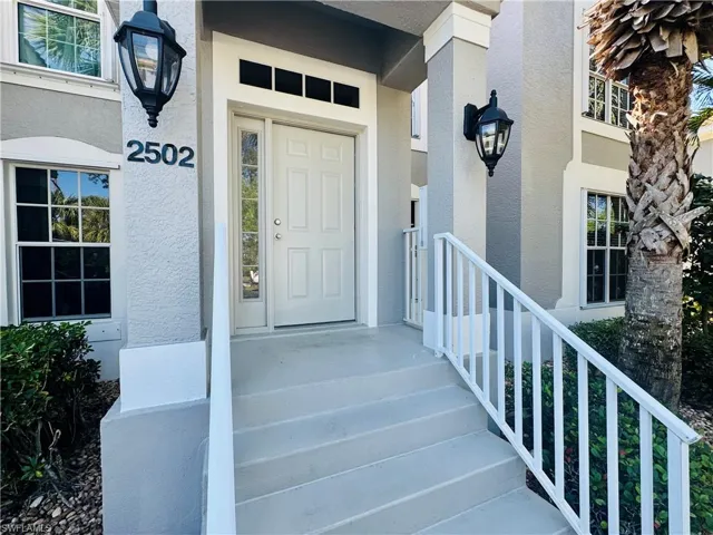 Doorway to property with stucco siding