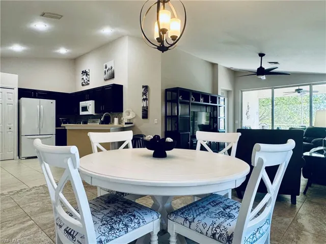 Dining room featuring lofted ceiling, recessed lighting, a ceiling fan, and visible vents