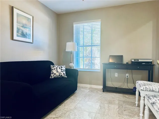 Living room featuring plenty of natural light and baseboards