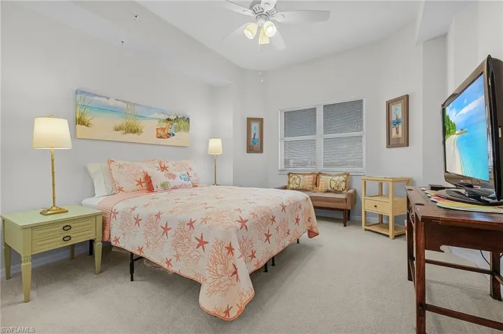 Carpeted bedroom with ceiling fan