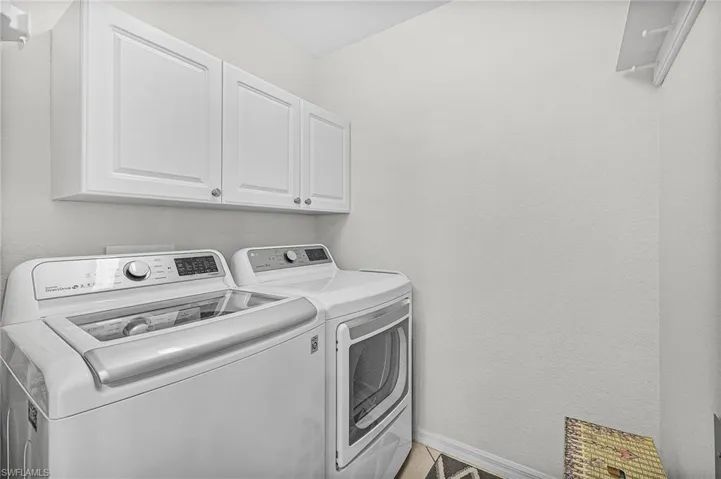 Washroom featuring cabinets and independent washer and dryer