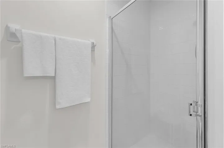 Interior details featuring a shower with door