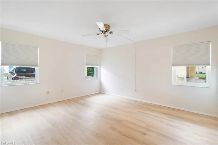 Empty room featuring ceiling fan and light hardwood / wood-style floors