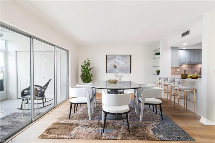 Dining space featuring light hardwood / wood-style floors virtually staged