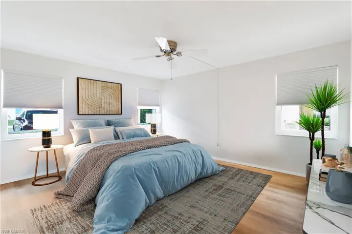 Bedroom featuring hardwood / wood-style floors and ceiling fan virtually staged