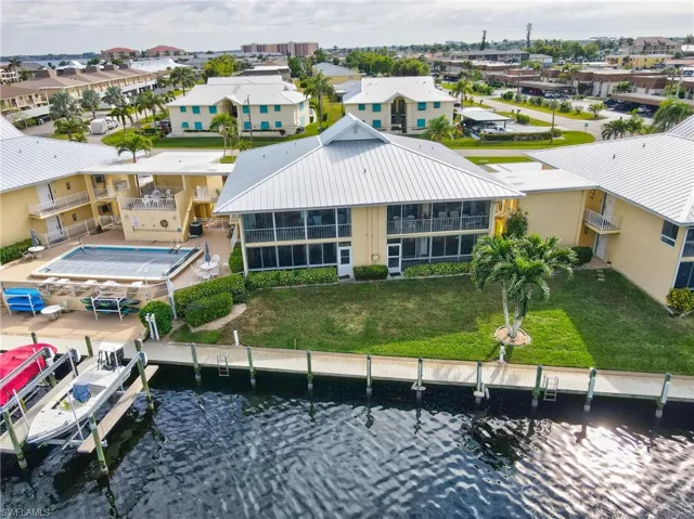 Birds eye view of property with a water view