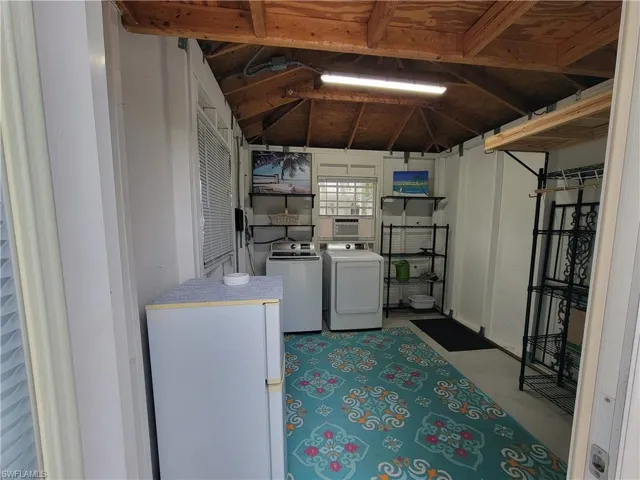 Below grade area featuring washer and clothes dryer and cooling unit