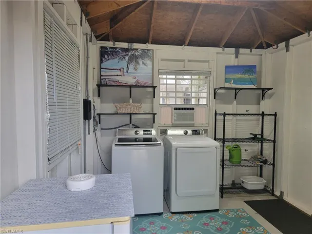Laundry room featuring cooling unit and independent washer and dryer