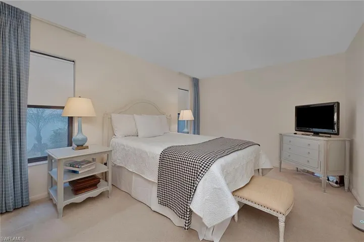 Bedroom with light colored carpet