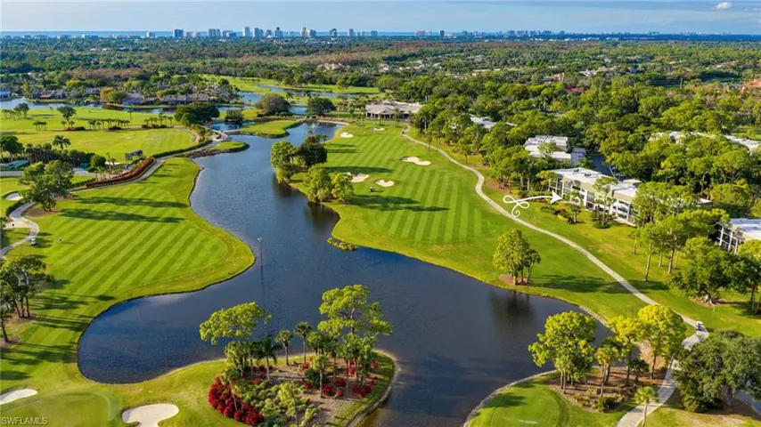 Aerial overview of property's location with a golf course and city skyline