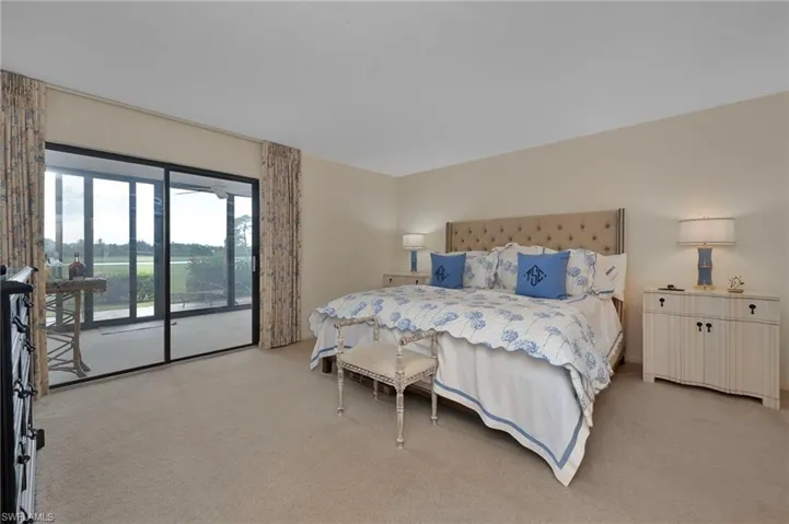 Bedroom featuring access to exterior and light carpet