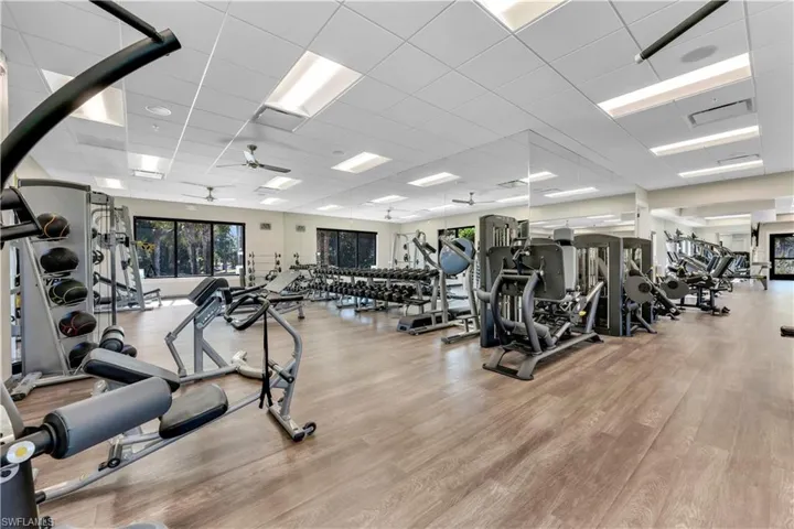 Workout area with a drop ceiling and a ceiling fan